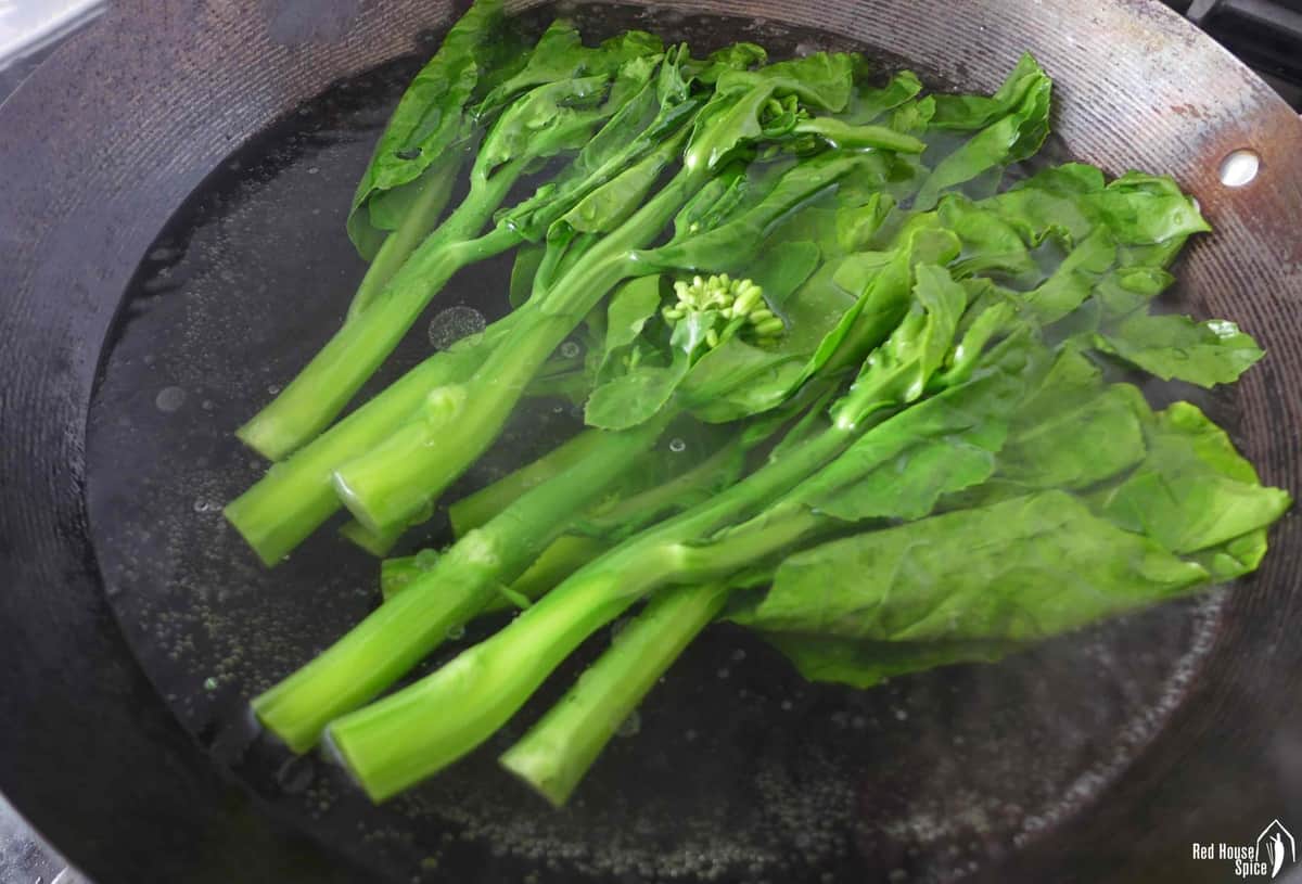 blanching Chinese broccoli in water.