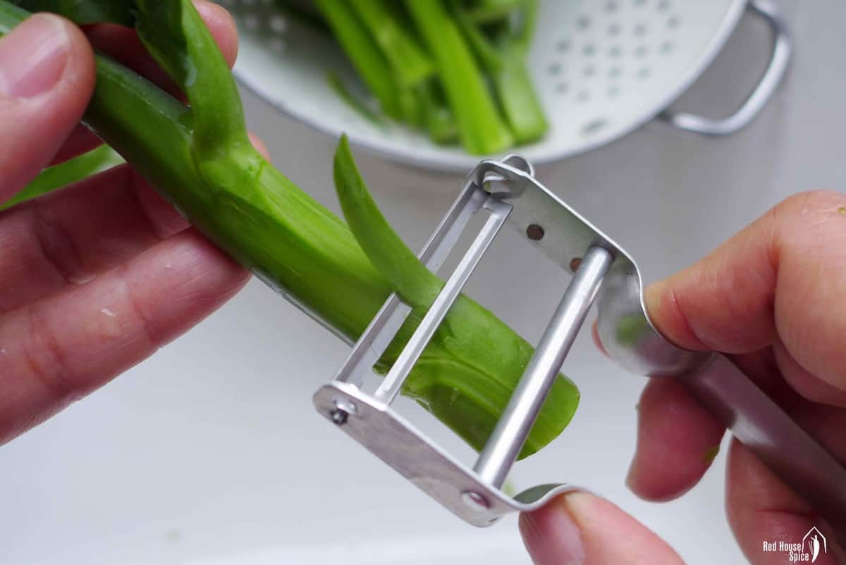 peeling the stem of Chinese broccoli