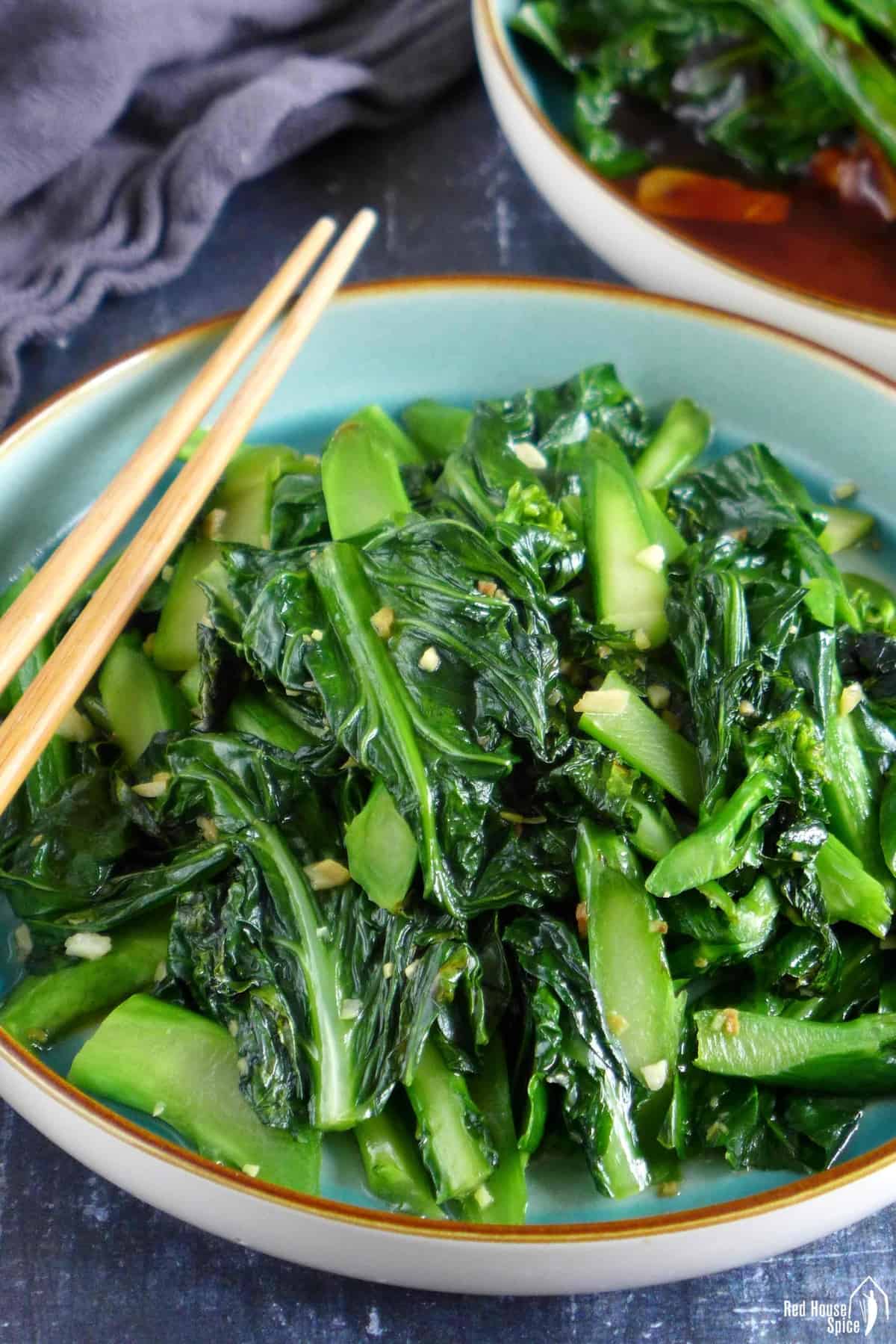 A plate of stir-fried Chinese broccoli with ginger and garlic.