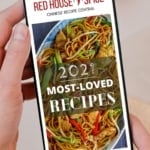 A mobile phone showing the homepage of Red House Spice website.