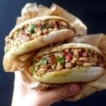 Two chinese pork burgers held by a hand