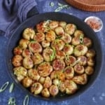 Baby potatoes with spices in a frying pan