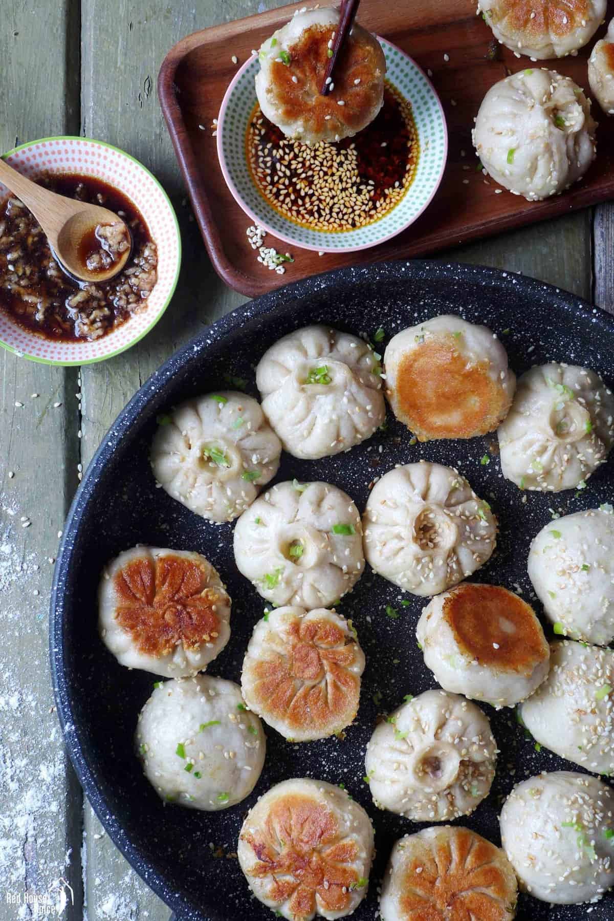 Pan fried pork buns with chili oil on the side