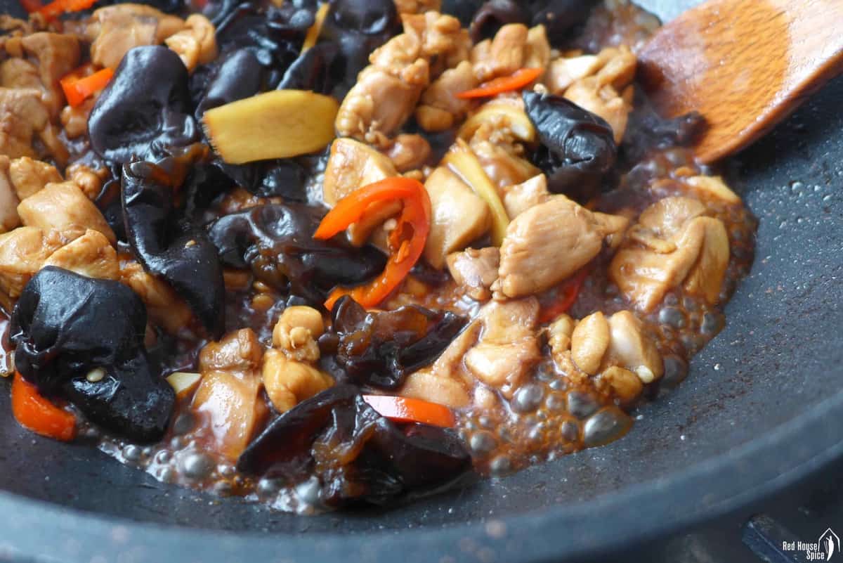 simmering chicken and wood ear in a wok