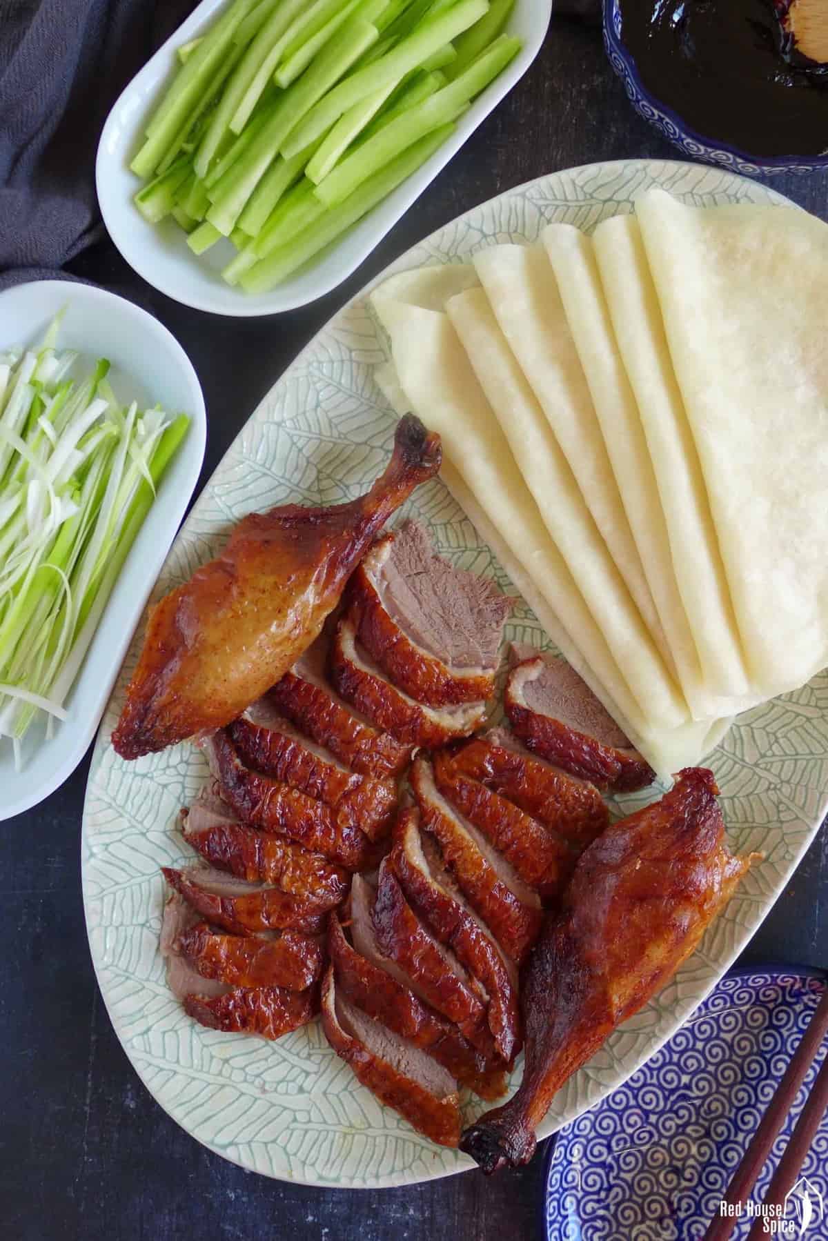 sliced Peking duck with thin pancakes, dark sauce, julienned cucumber and scallions.