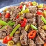 A plate of Hunan beef with overlay text that says Hunan beef stir-fry