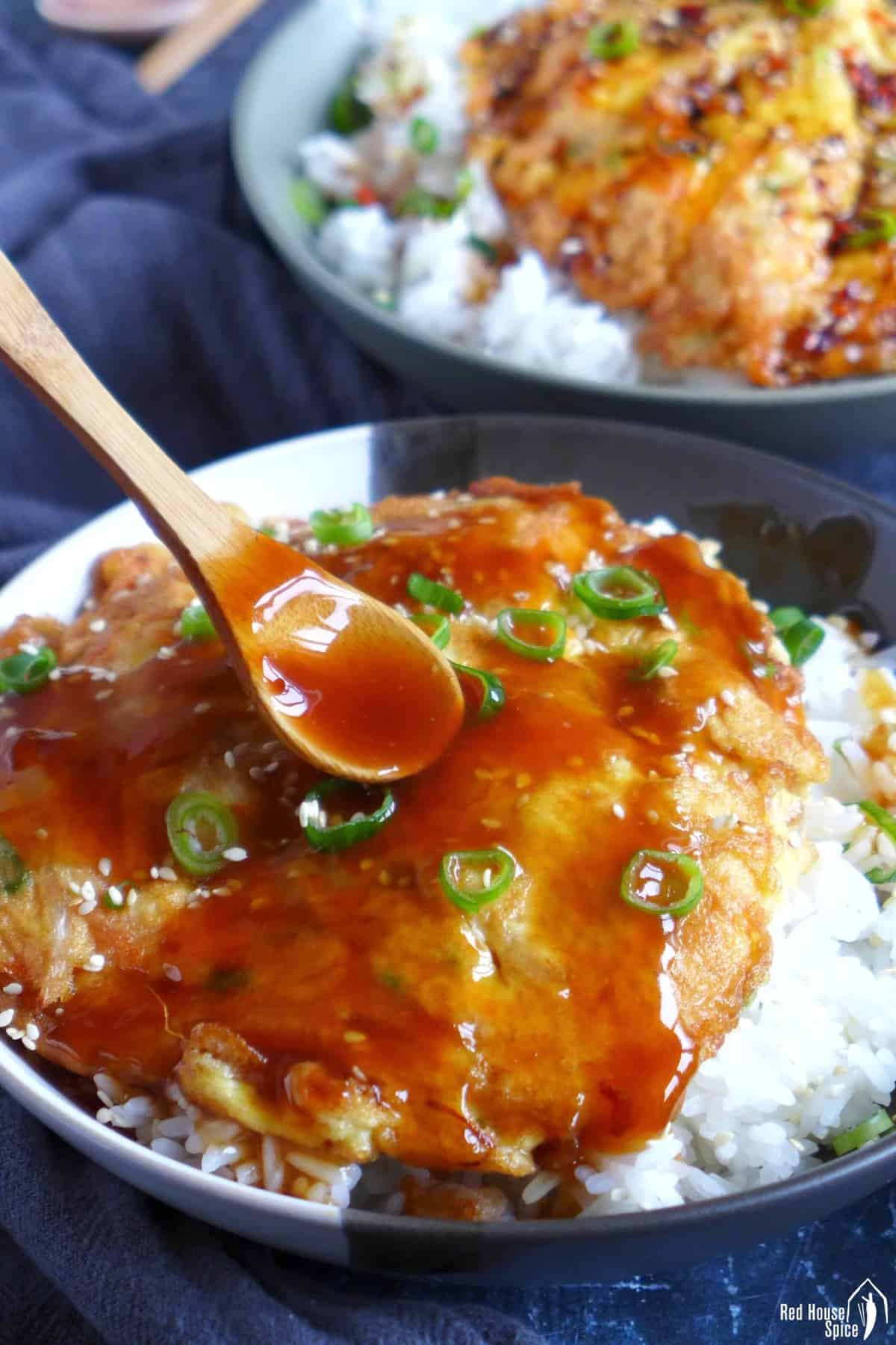 spooning gravy over egg foo young