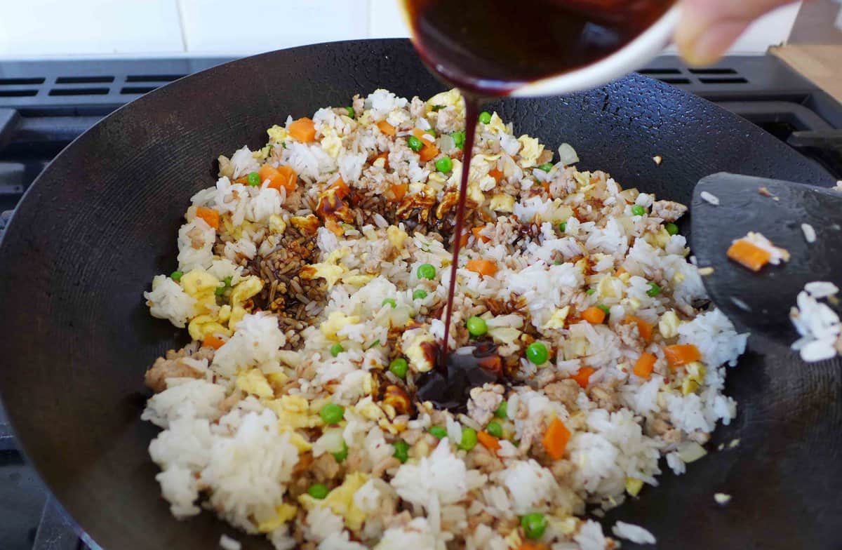 adding sauce to fried rice