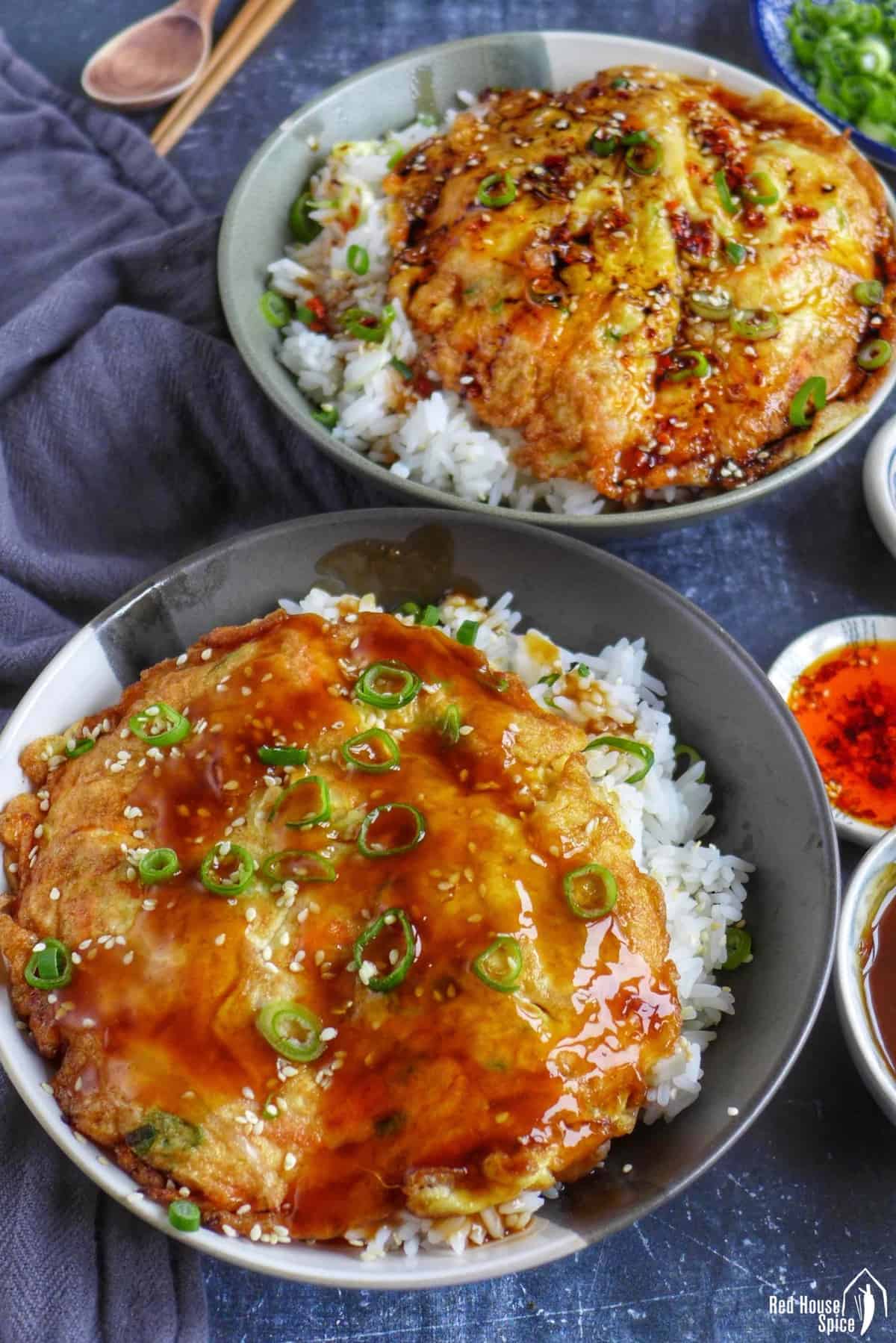two bowls of egg foo young over rice