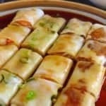 Cheung fun cut into pieces with overlay text that says rice noodle rolls
