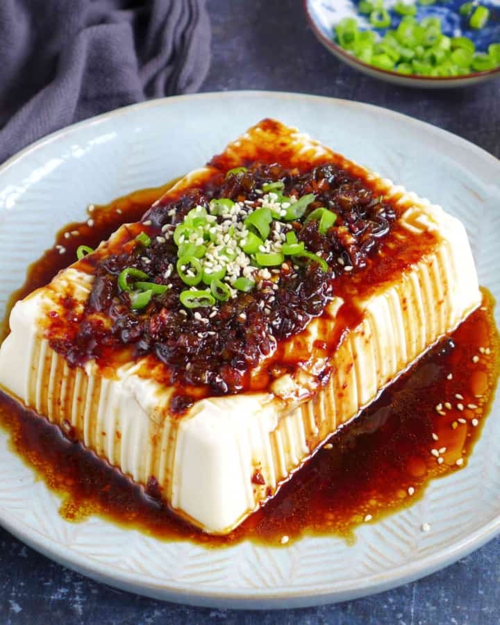 a block of silken tofu with scallion and soy dressing