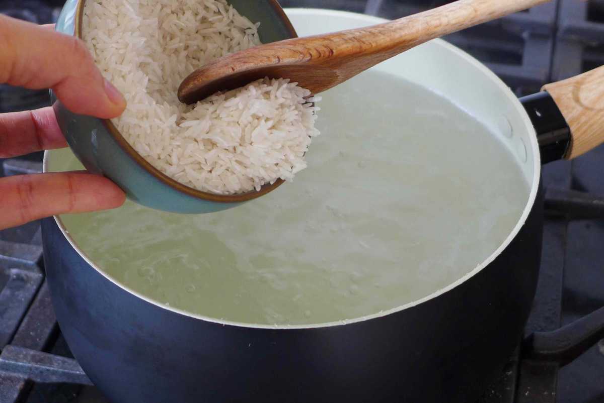 adding rice to boiling water