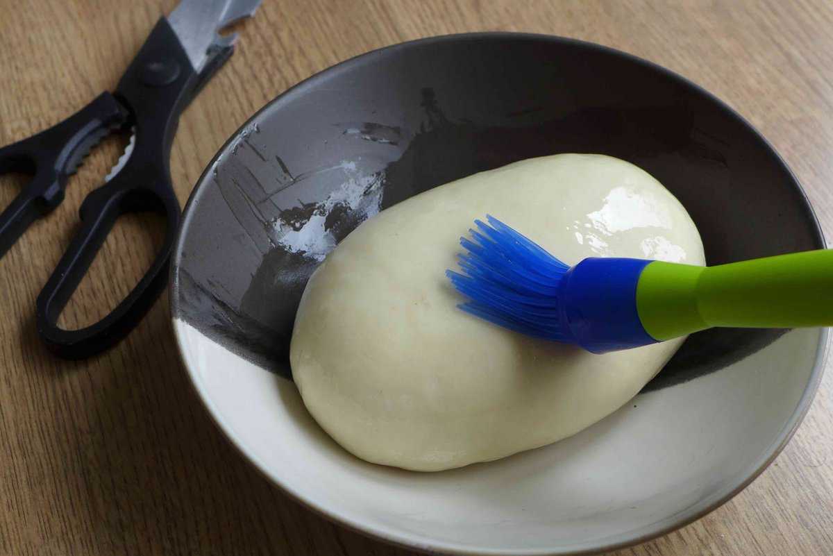 brushing oil over dough