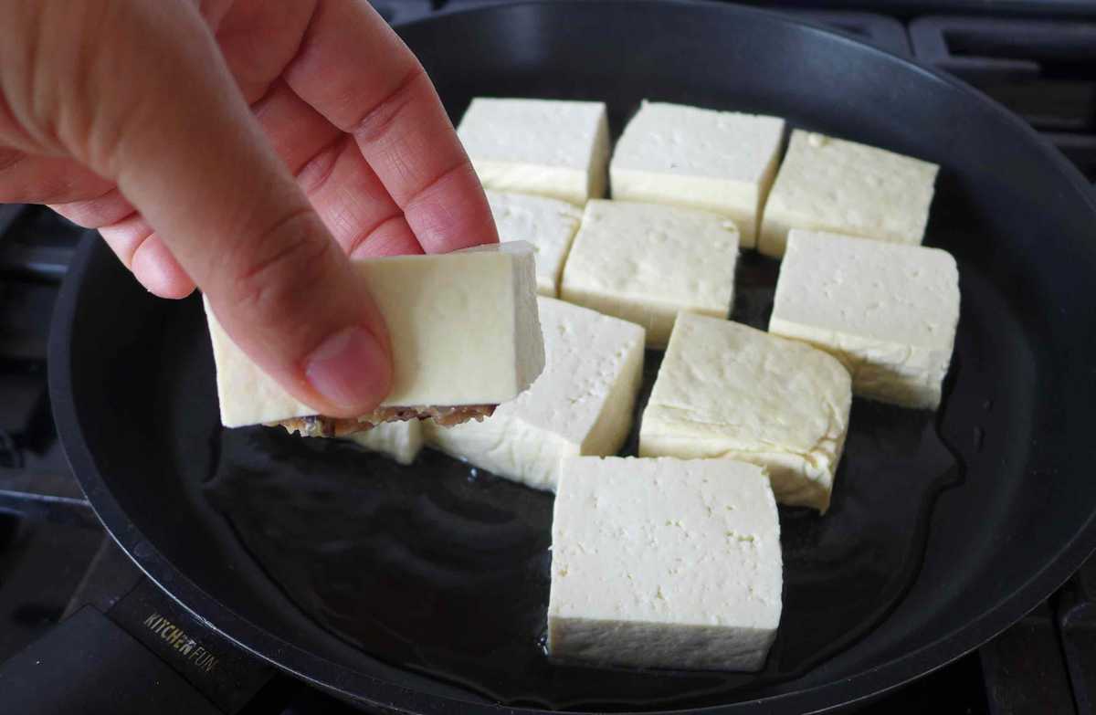 putting tofu blocks into a pan