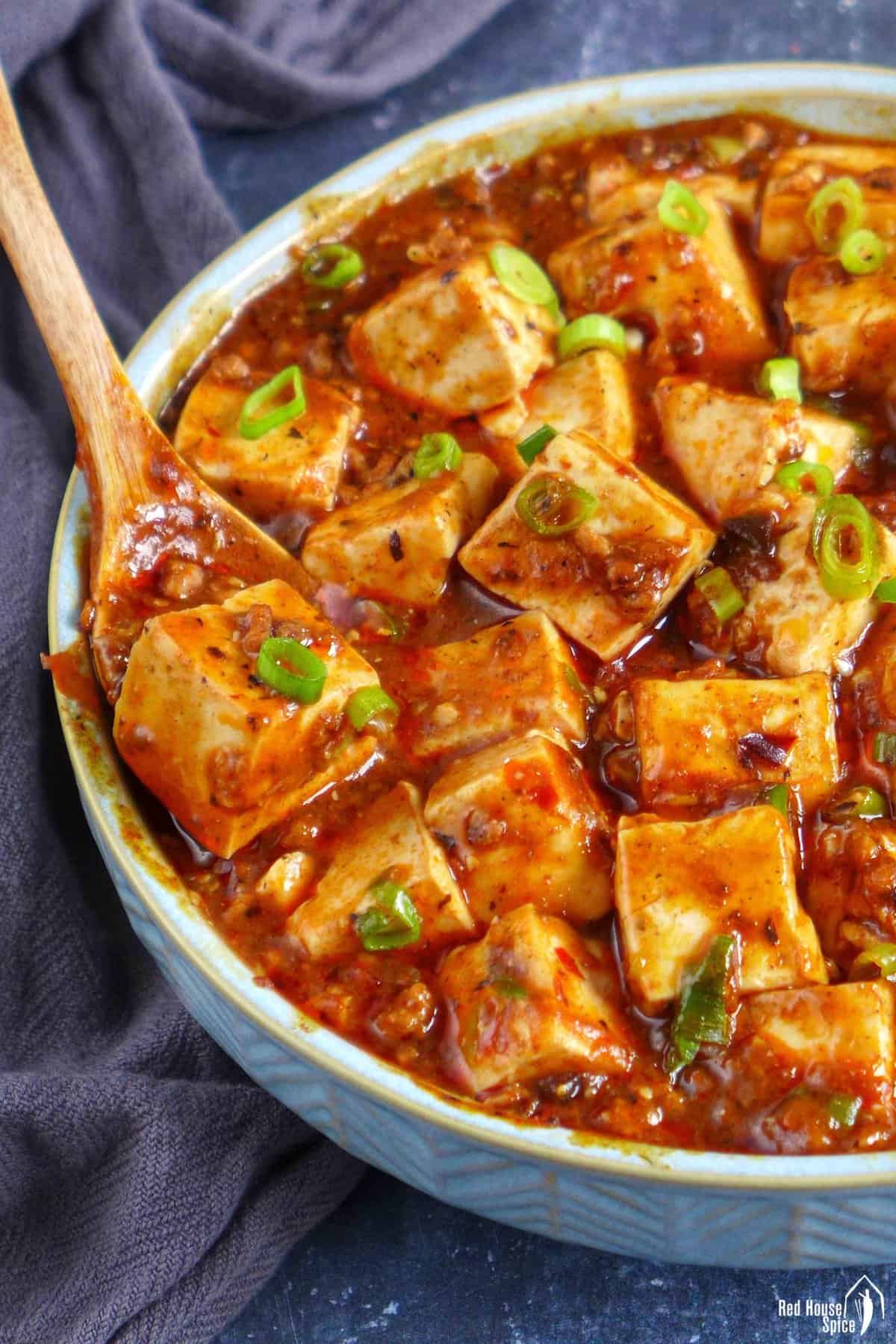 spooning out one piece of Mapo tofu