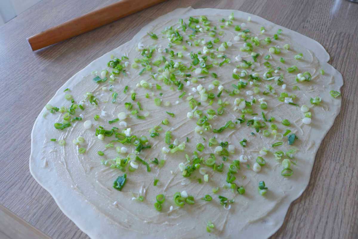 scallions over a thin piece of dough