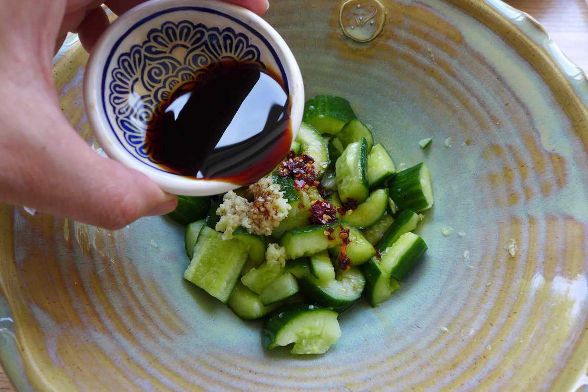 adding soy sauce to cucumber