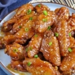 cooked chicken wings with overlay text that says cola chicken wings