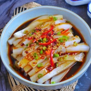 A plate of mung bean jelly noodles with sauce and toppings.
