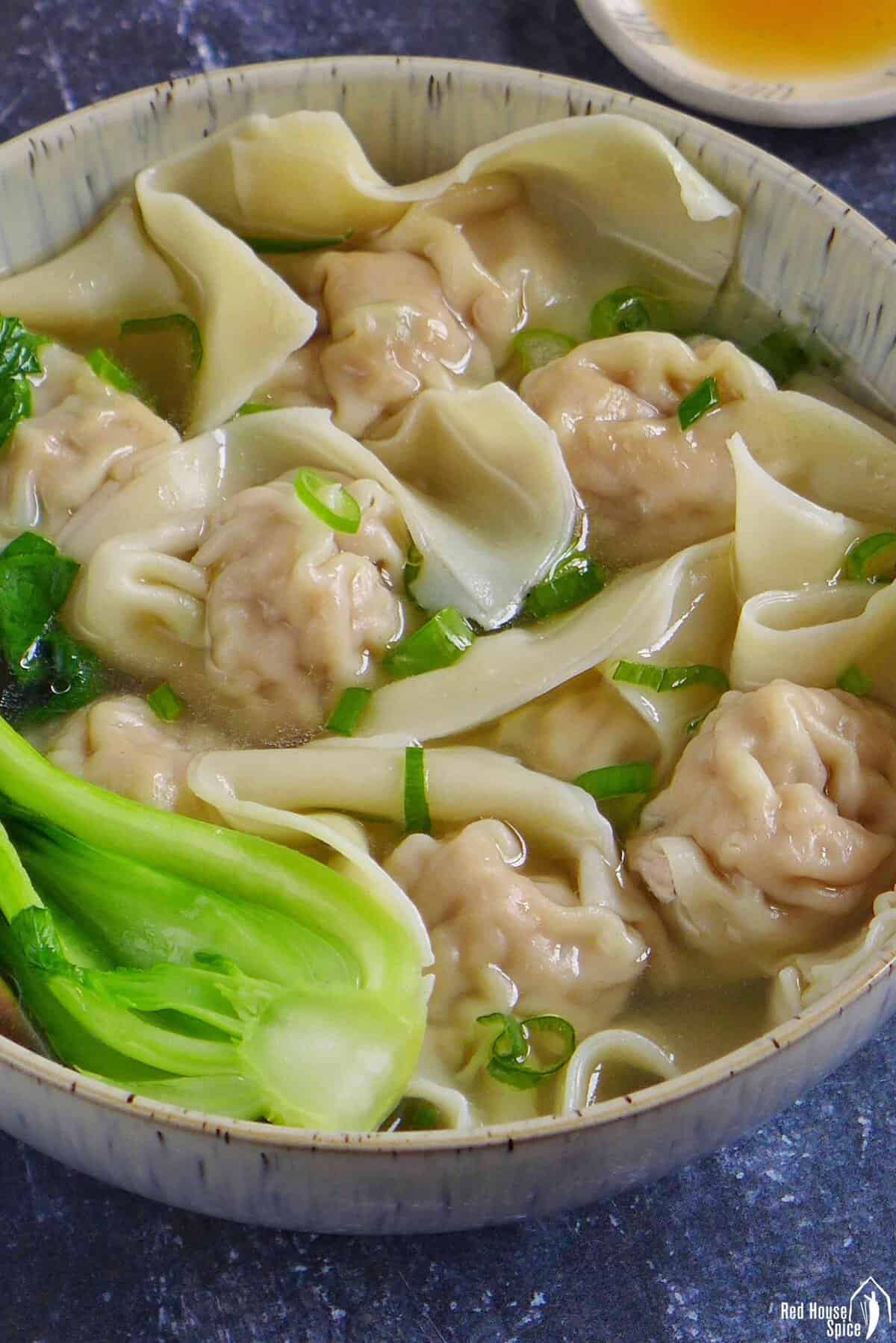 cooked wontons in chicken stock.