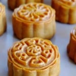 Baked round mooncakes with overlay text that says Chinese mooncakes.