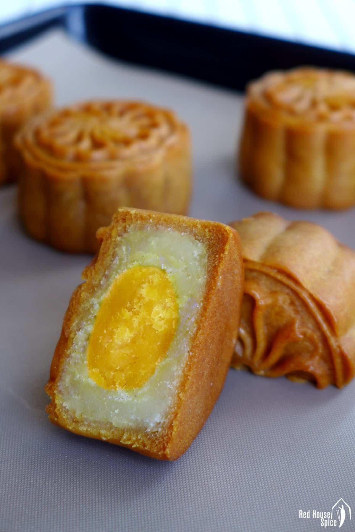 A halved mooncake showing its lotus paste and salted yolk filling.