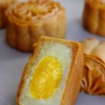 A halved mooncake with overlay text that says salted yolk mooncake.