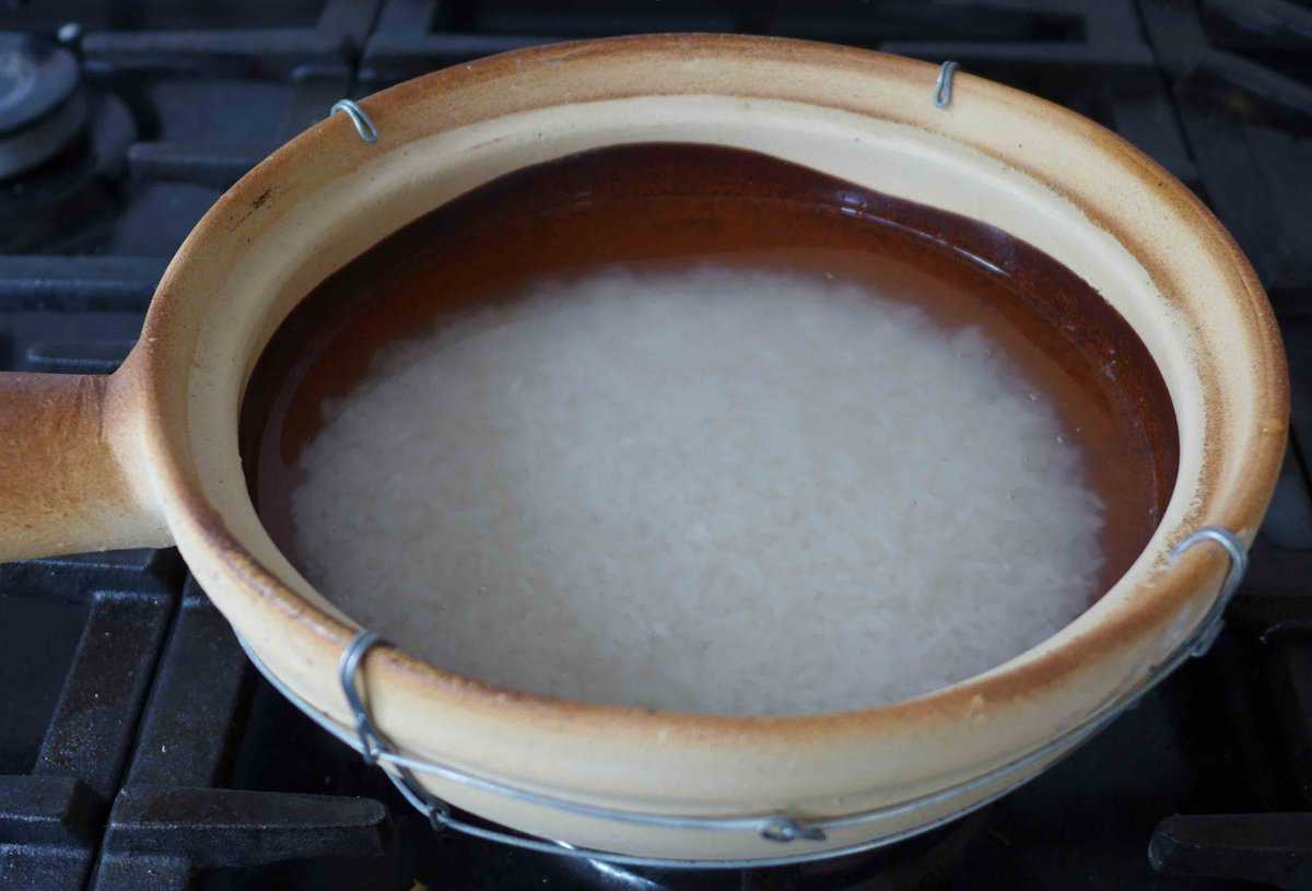 rice and water in a clay pot.