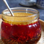 Chili oil in a jar with a spoon.