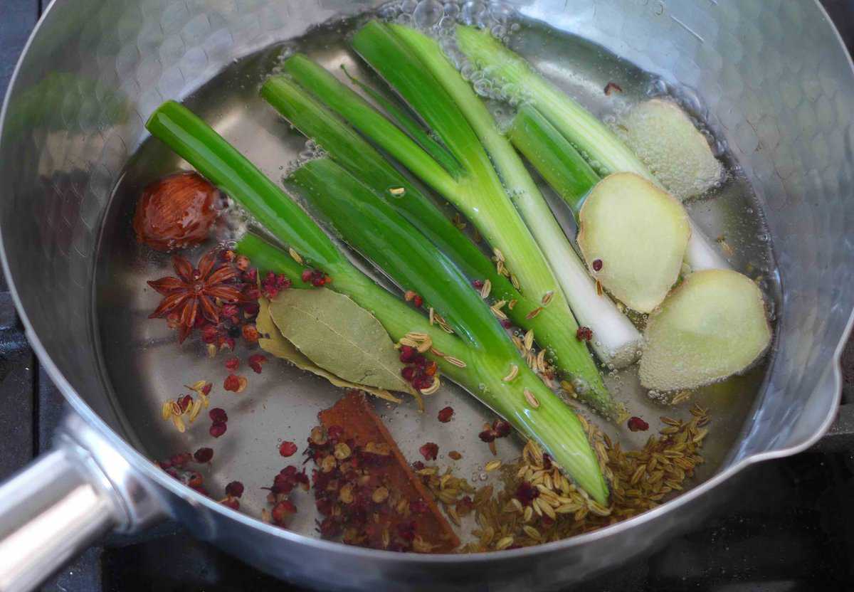 simmering spices and aromatics in oil.