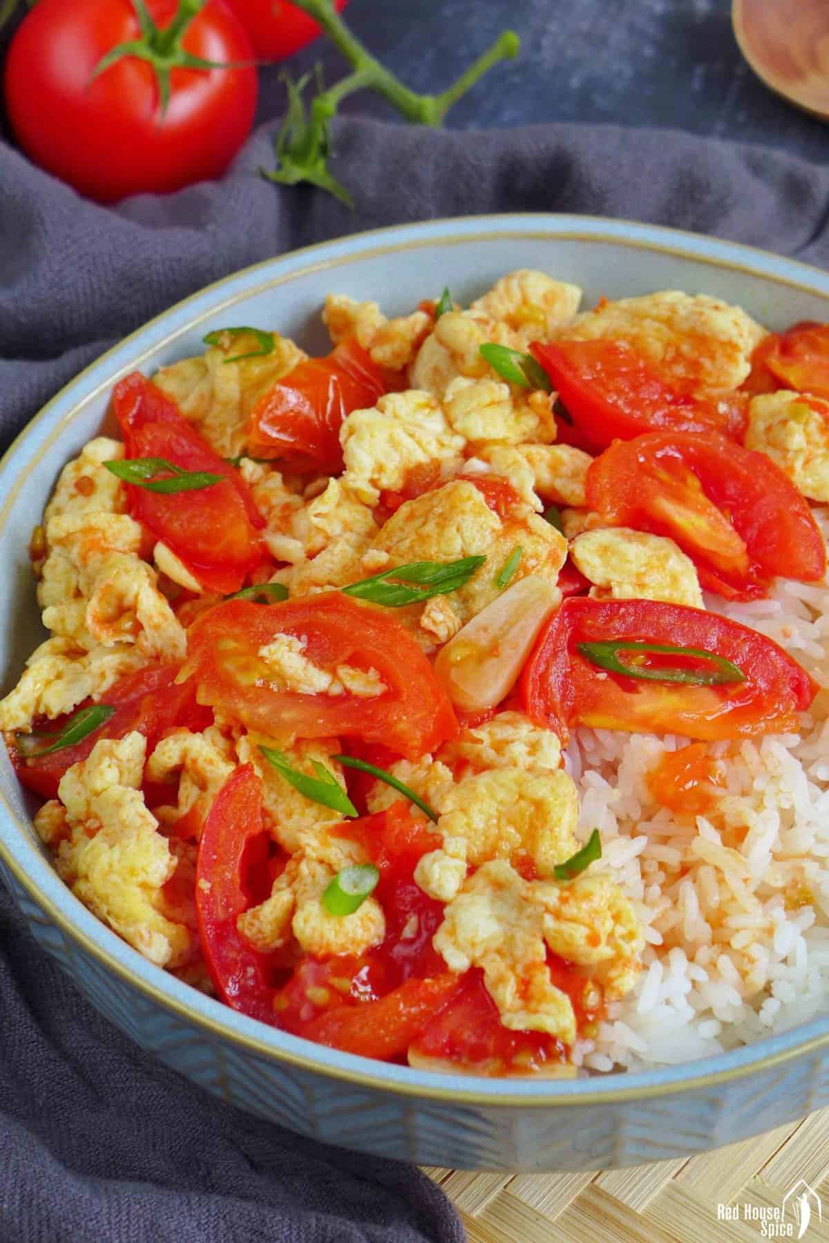 tomato and egg stir-fry over steamed rice.