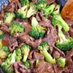 stir-frying beef and broccoli in a wok.