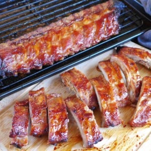 BBQ ribs on a chopping board and on a tray.