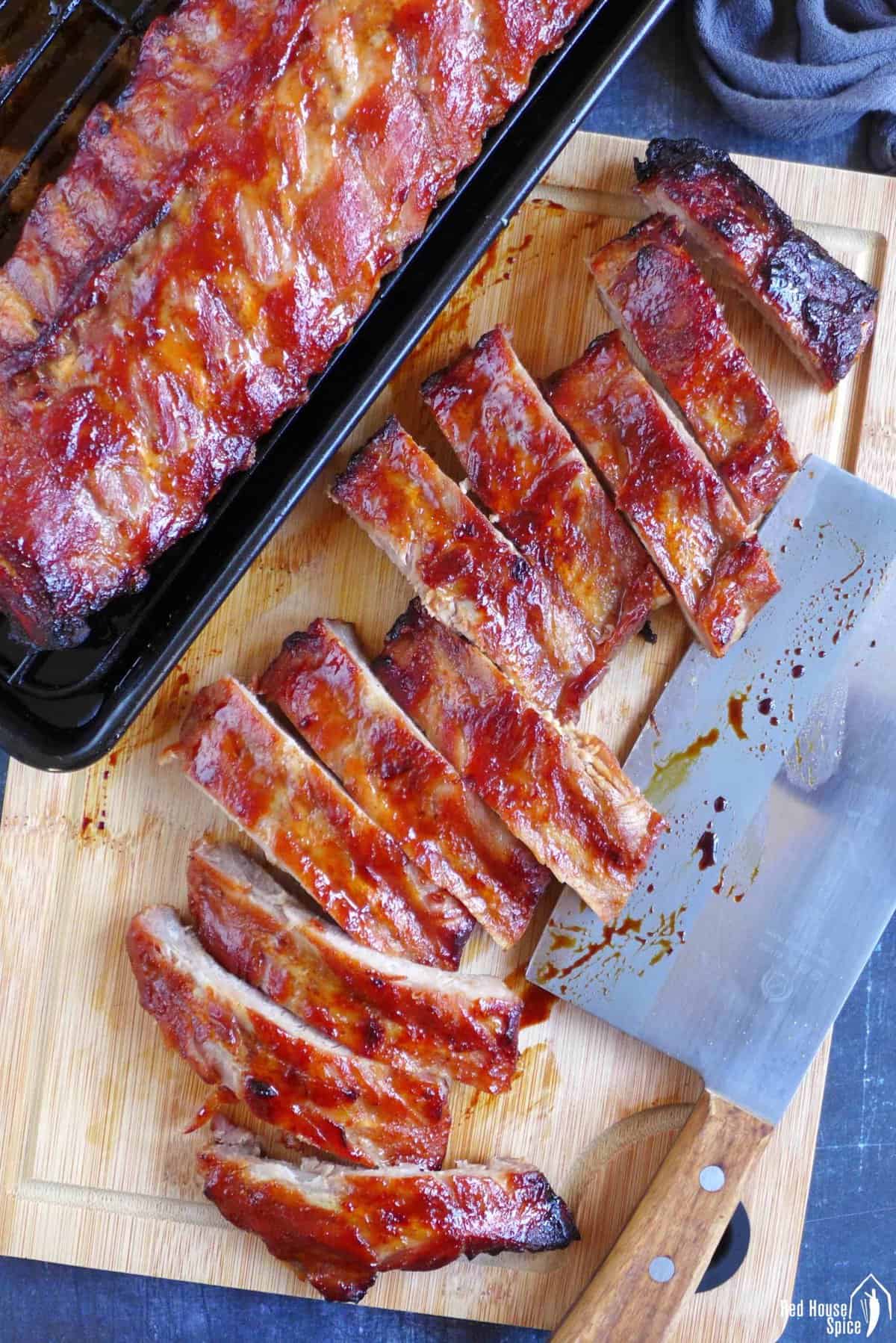 Chinese BBQ ribs on a chopping board.