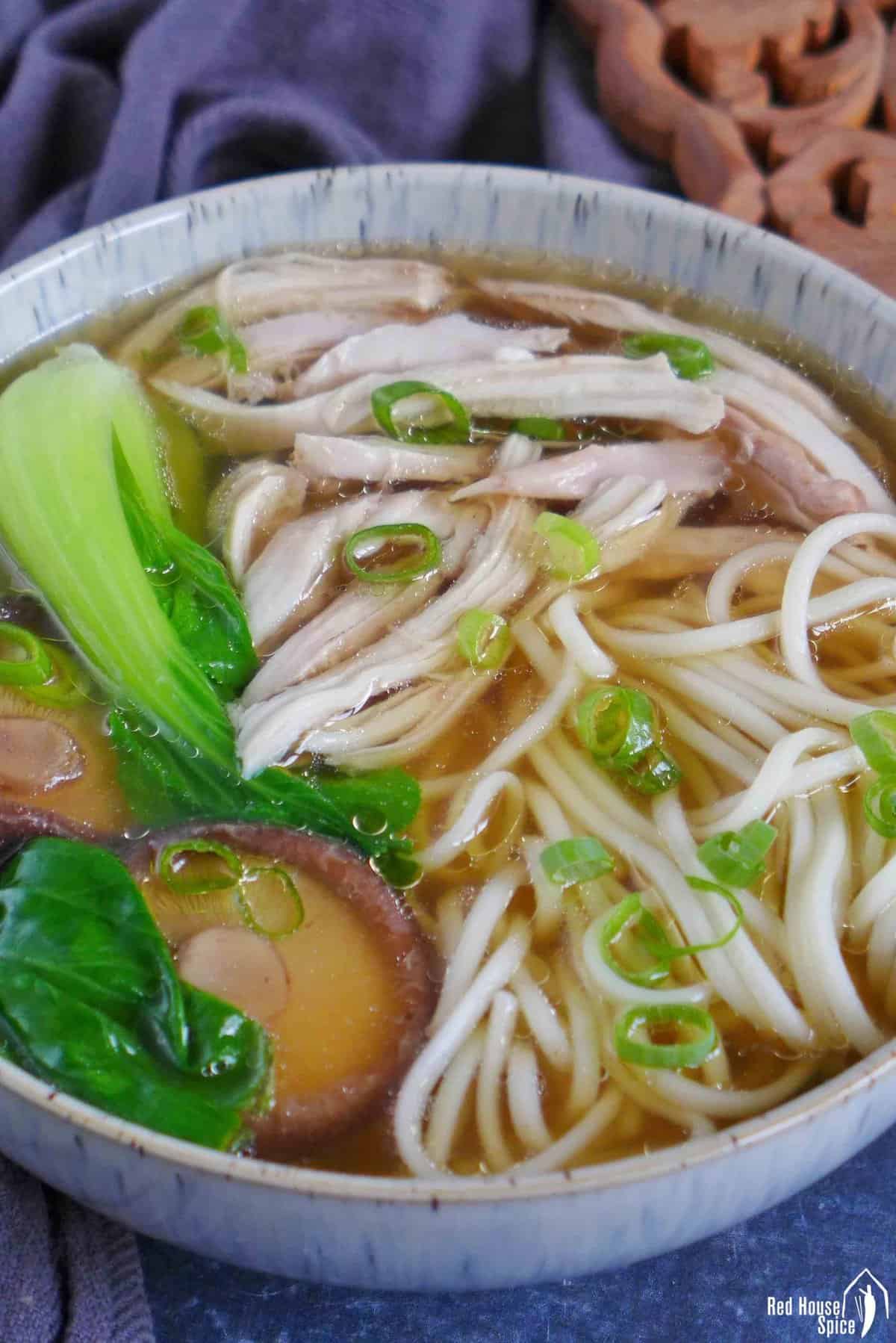shredded chicken, noodles, mushroom and Bok Choy in soup.