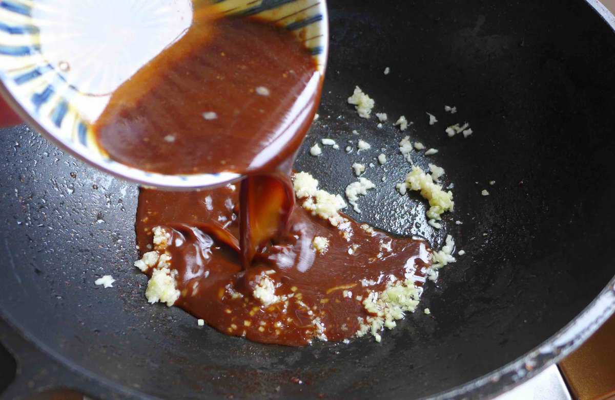 pouring sauce to a wok.