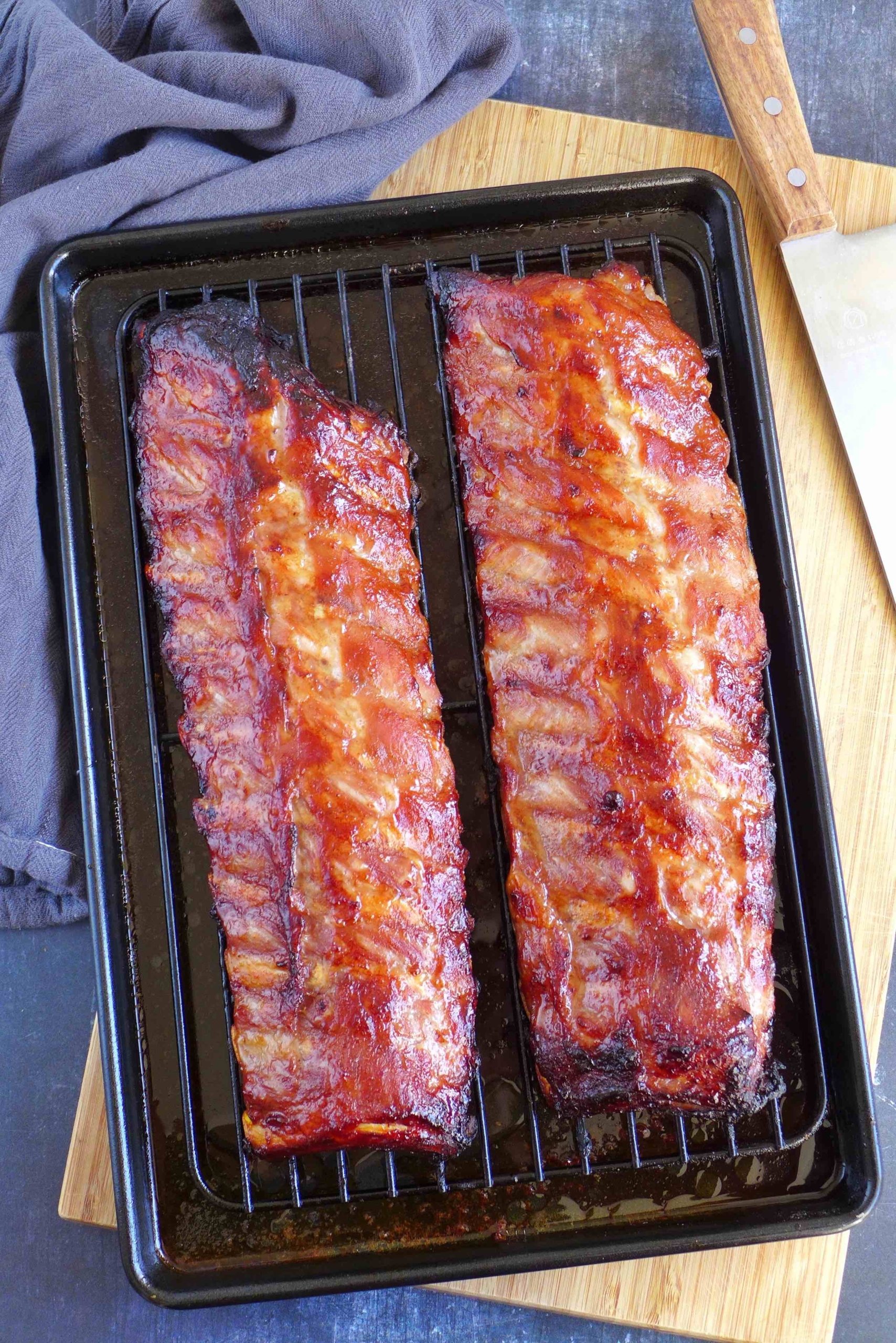 two racks of Chinese BBQ ribs on a baking tray.
