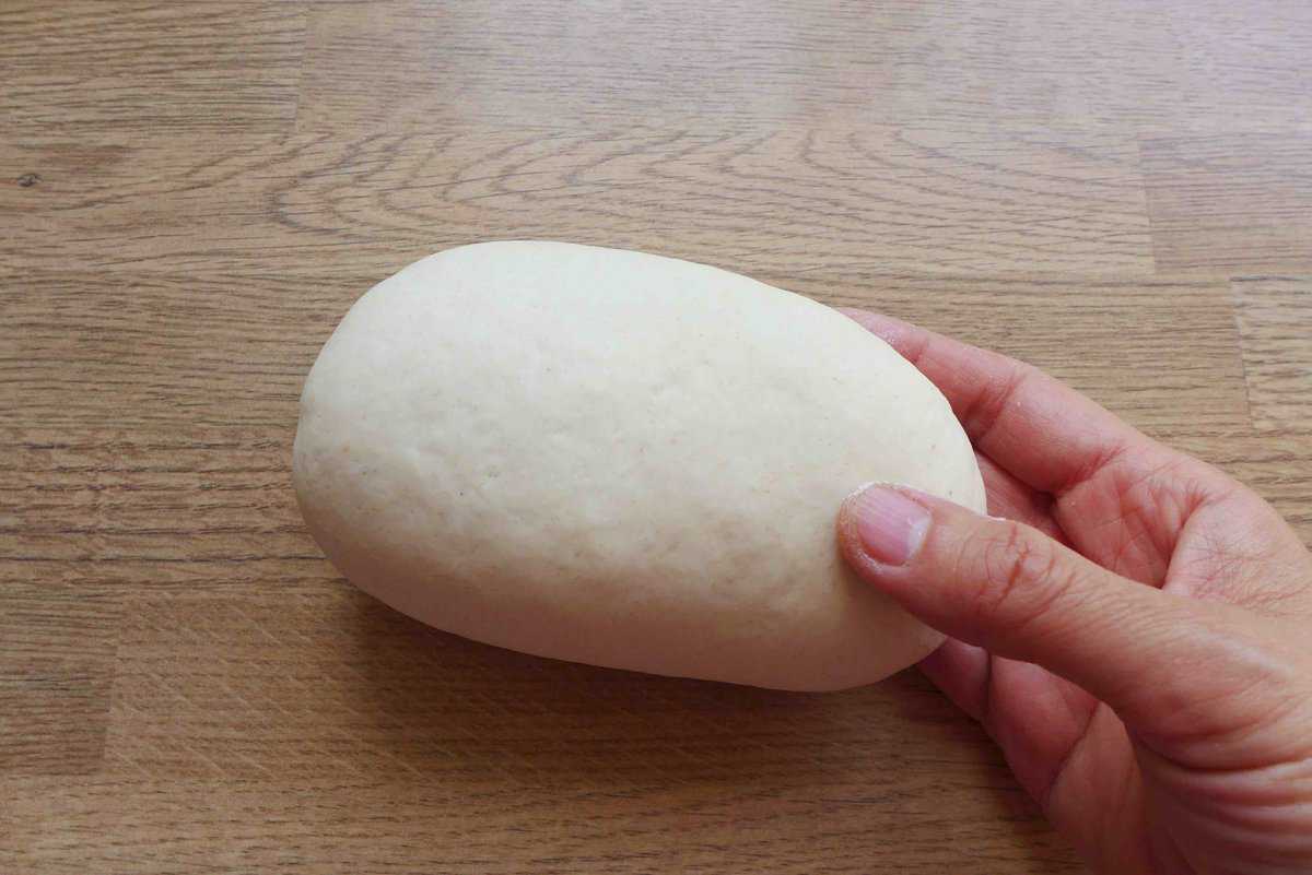 A smooth dough held by a hand.