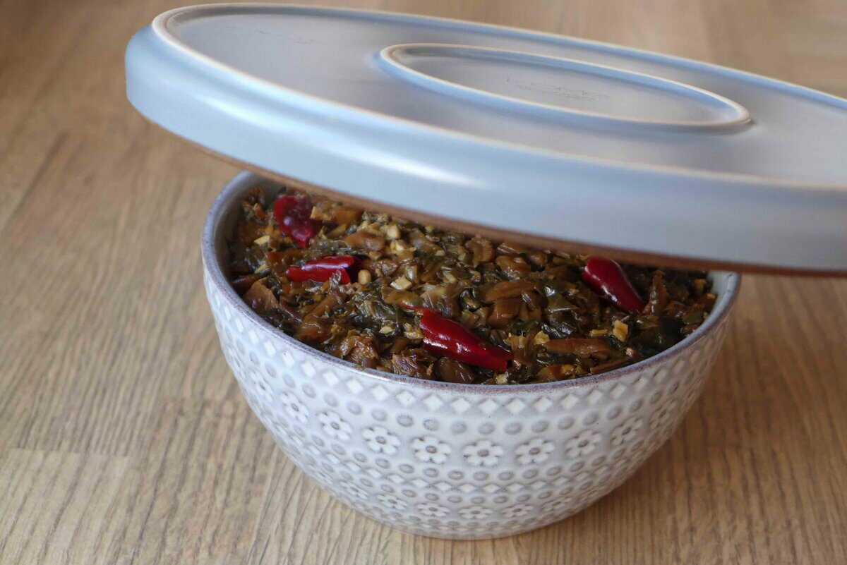 cover a bowl filled with Mei Cai with a plate.