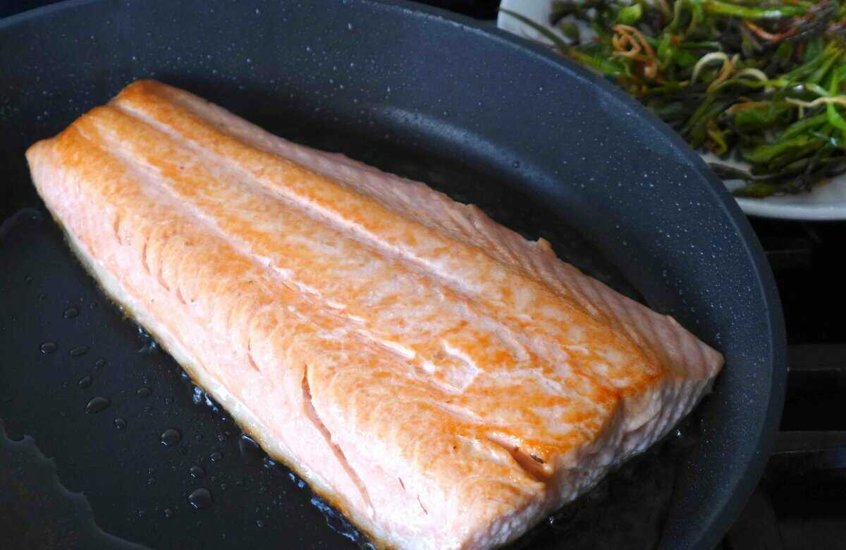 frying the skin side of a salmon filet.