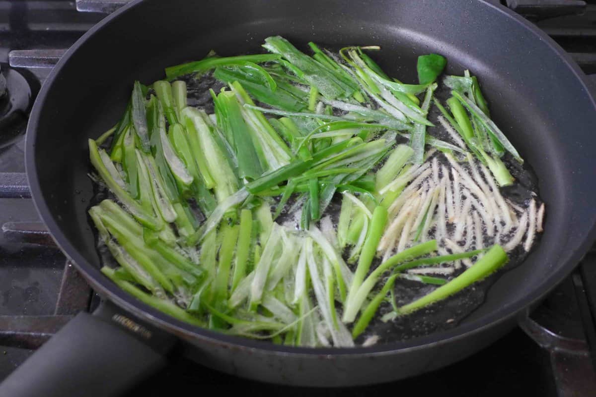 frying scallions and ginger in oil.