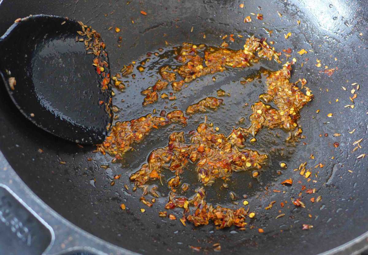frying cumin seeds and chili flakes.