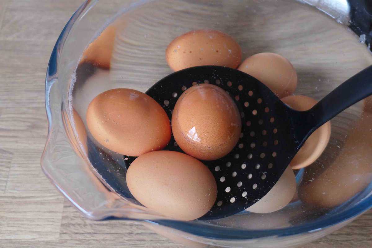 putting eggs into cold water.