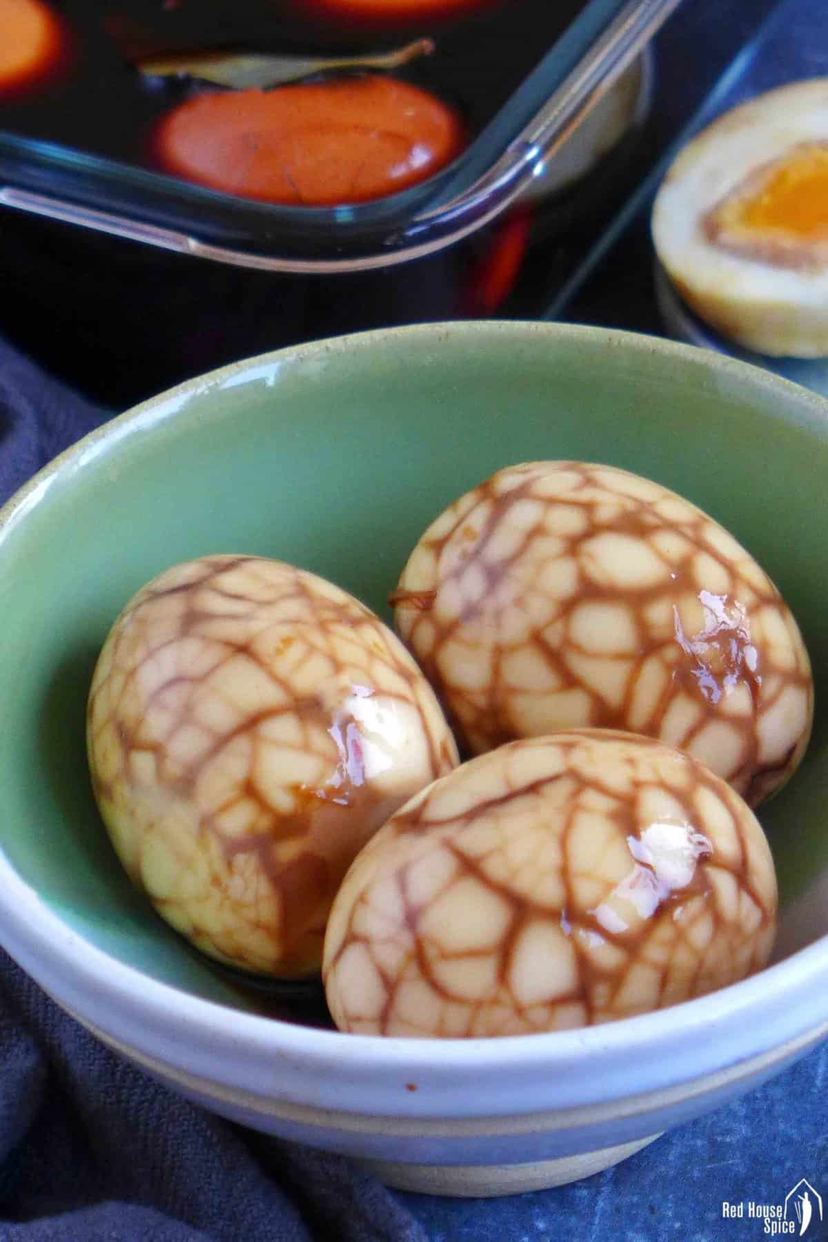 three Chinese tea eggs with marbled pattern.