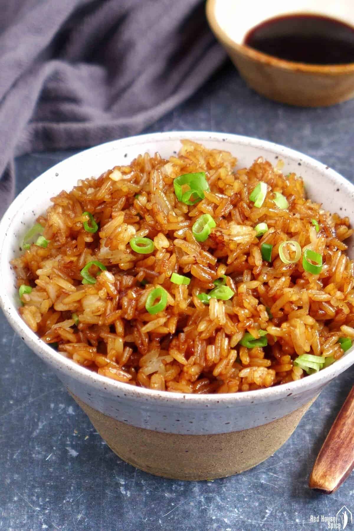 Chinese soy sauce fried rice in a bowl.
