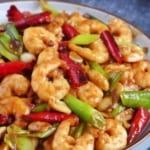 A plate of stir-fried Kung Pao Shrimp with overlay text that says Kung Pao Shrimp.