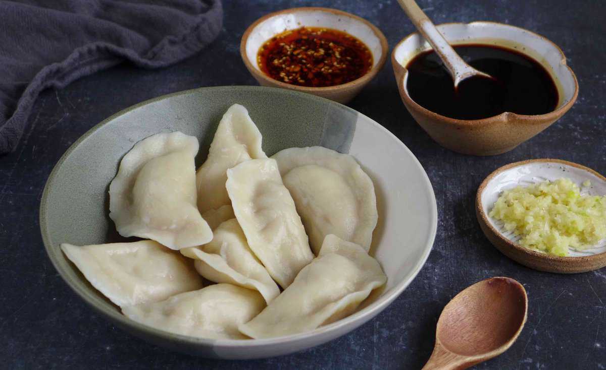 cooked dumplings with sauces on the side.