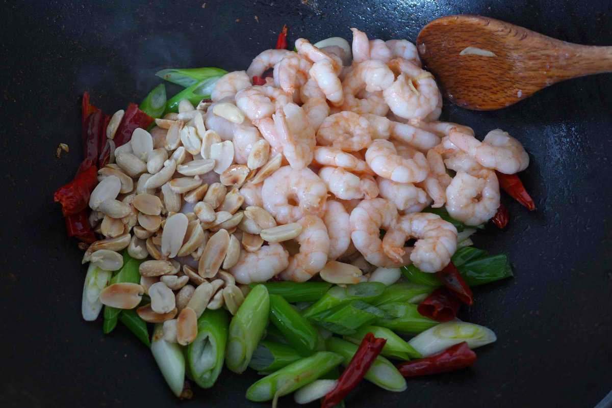 cooked shrimp and peanuts over scallions.