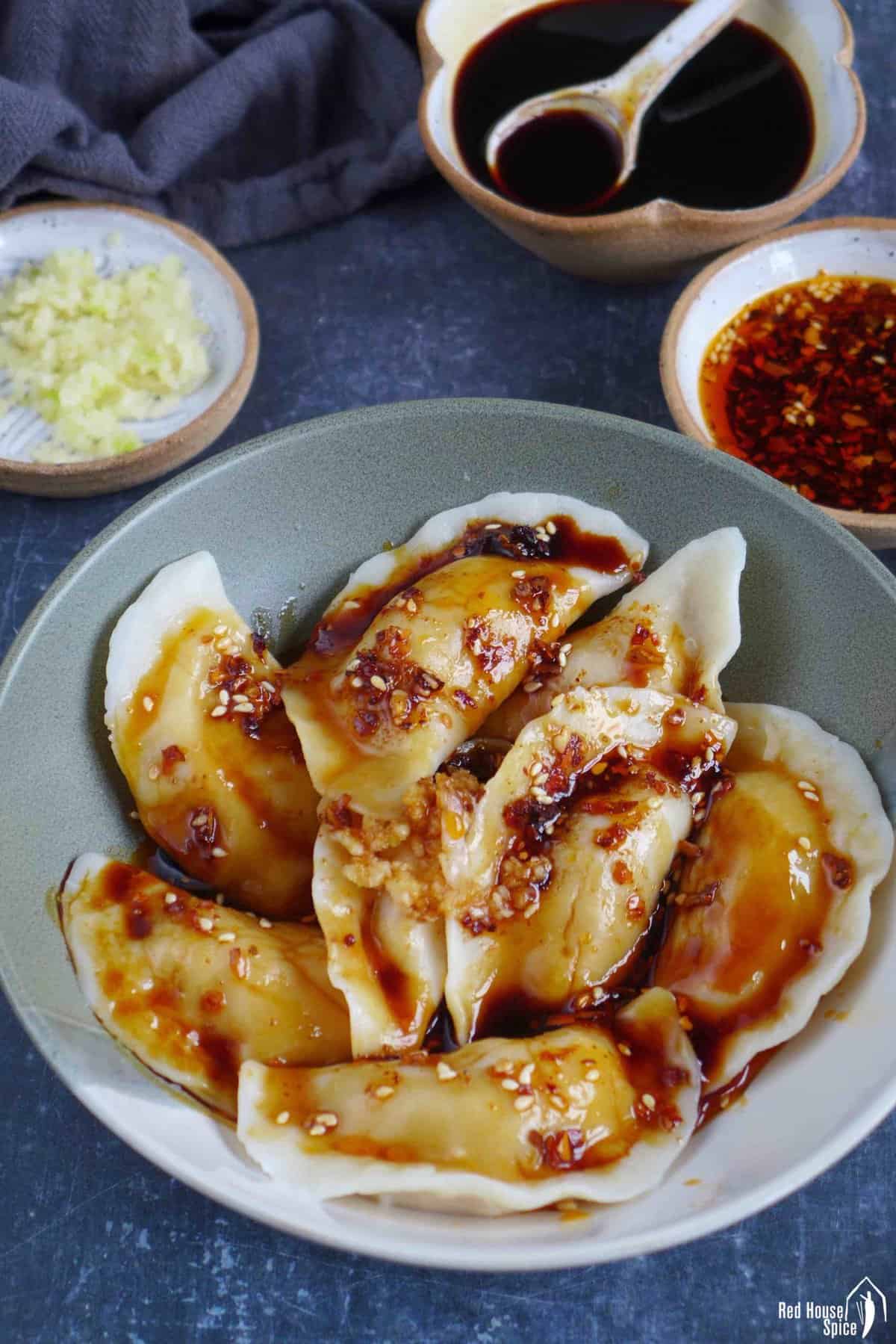 boiled dumplings seasoned with sweet soy sauce and chili oil.