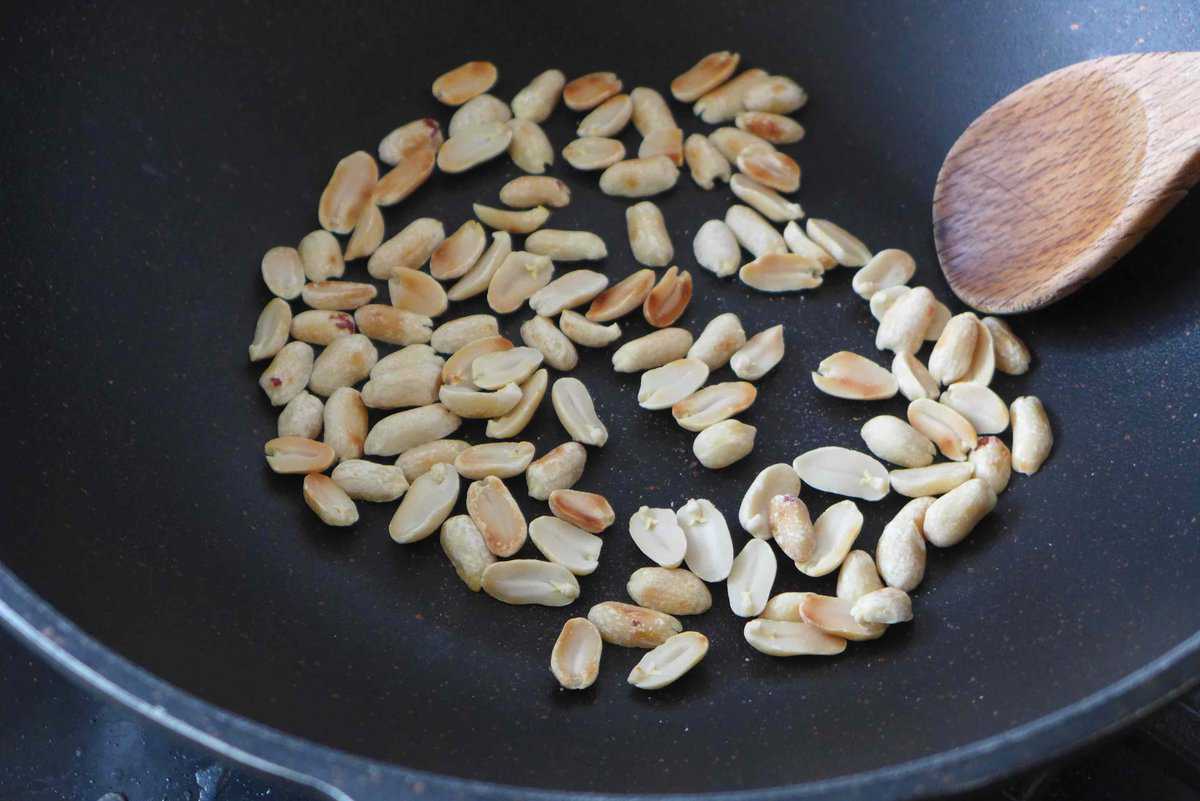 Toasting peanuts in a pan.
